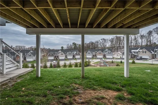 a view of a porch in front of a house with a backyard