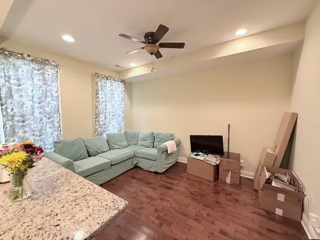 a living room with furniture rug and wooden floor