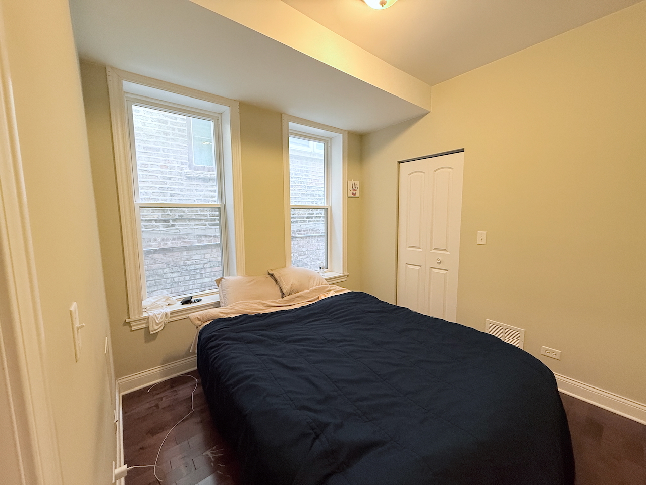 2649 West 21st Place Chicago, IL 60608 - Photo 21 of 26 a bedroom with a bed and a window