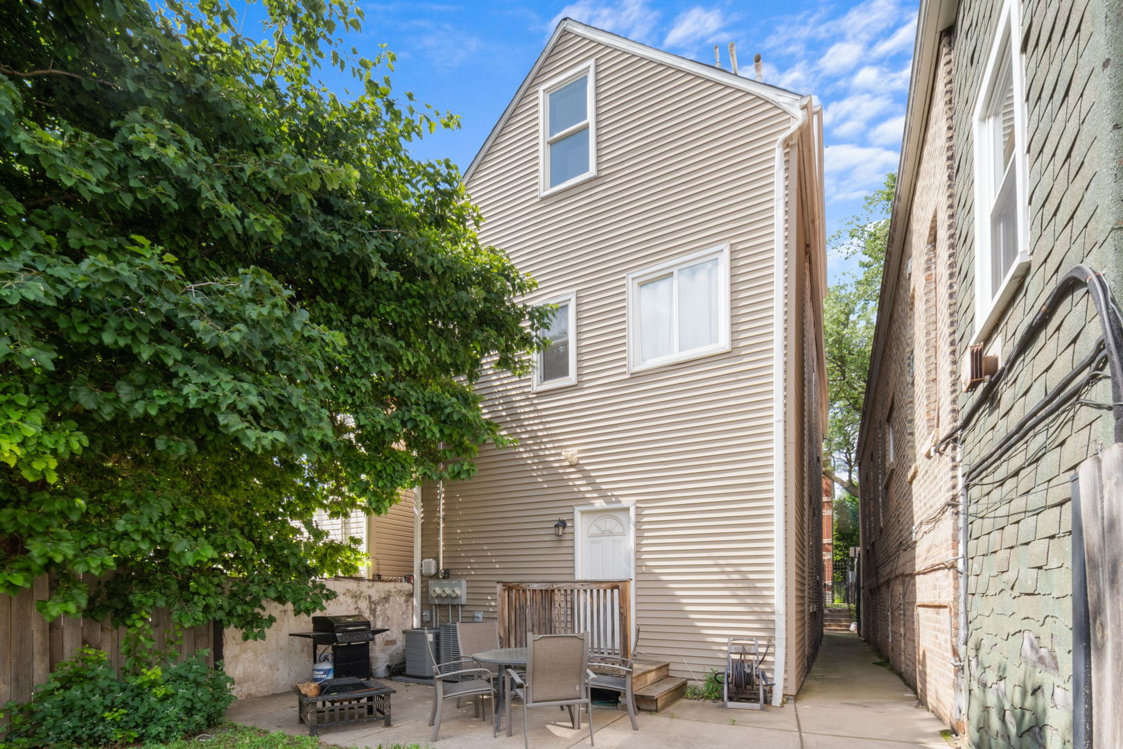 2649 West 21st Place Chicago, IL 60608 - Photo 24 of 26 a view of backyard with potted plants and a large tree