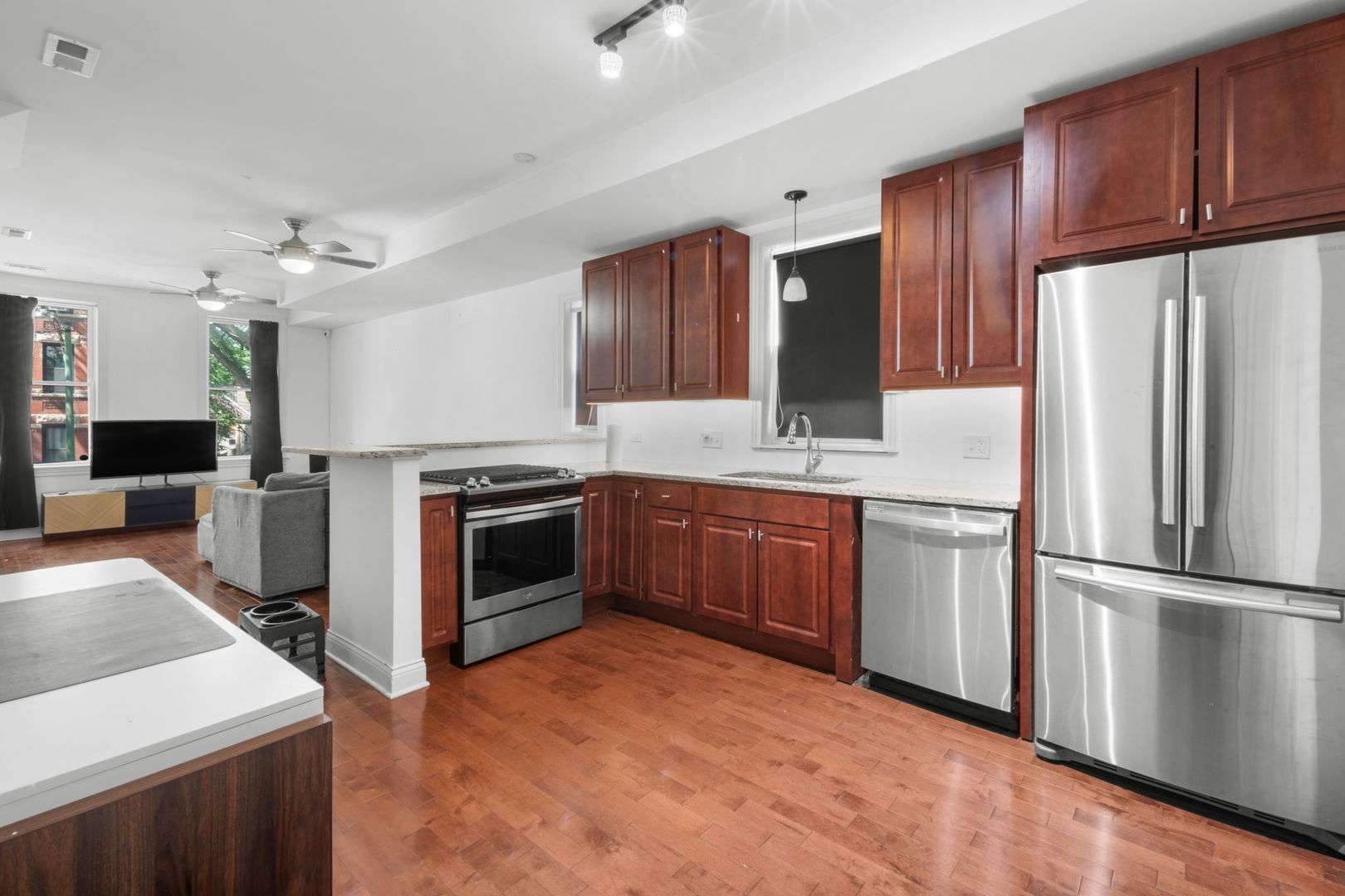 2649 West 21st Place Chicago, IL 60608 - Photo 4 of 26 a kitchen with stainless steel appliances a stove a sink and a refrigerator