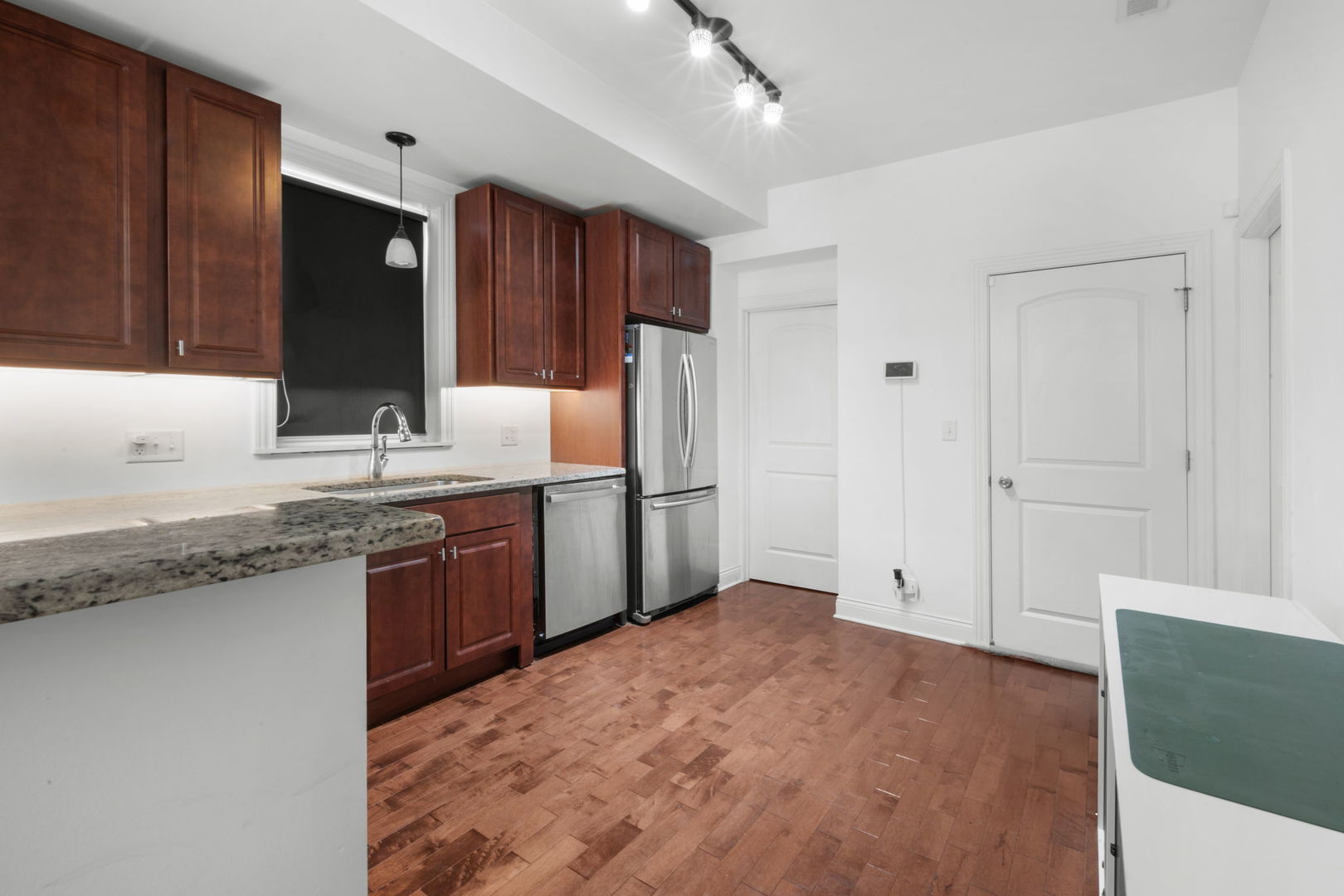 2649 West 21st Place Chicago, IL 60608 - Photo 5 of 26 a kitchen with stainless steel appliances granite countertop a refrigerator and a sink