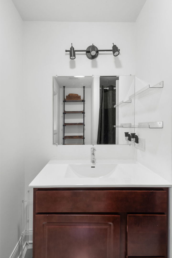 2649 West 21st Place Chicago, IL 60608 - Photo 9 of 26 a bathroom with a sink and a mirror