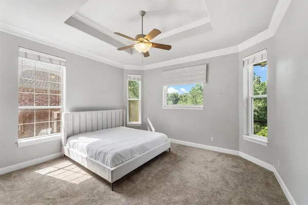 a large bedroom with a bed and a window