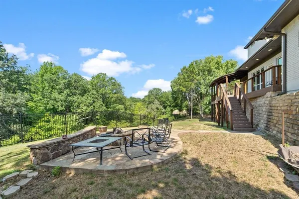 a view of a patio with a table and chairs