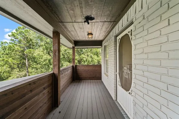 a view of hallway with a large window and wooden floor
