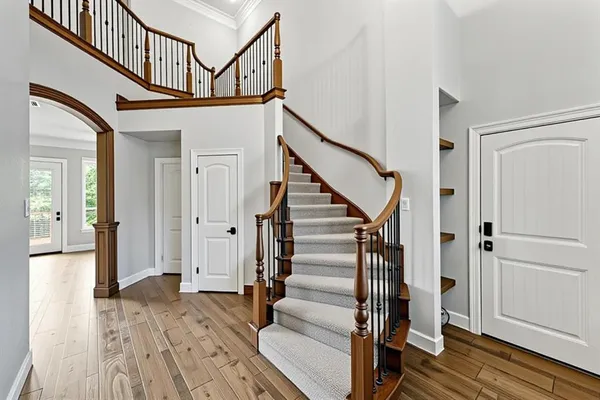 a view of entryway with wooden floor and stairs