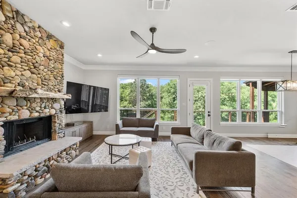 a living room with fireplace furniture and a flat screen tv