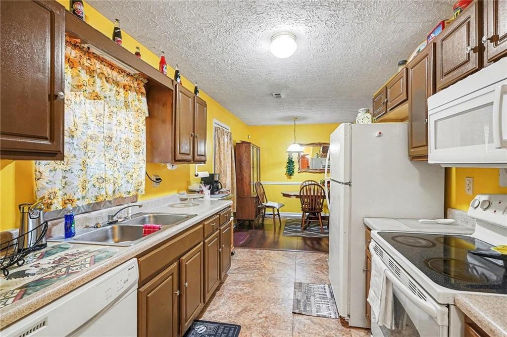 204 Hailey Lane Griffin, GA 30223 - Photo 12 of 32 a kitchen with a sink stove top oven and refrigerator