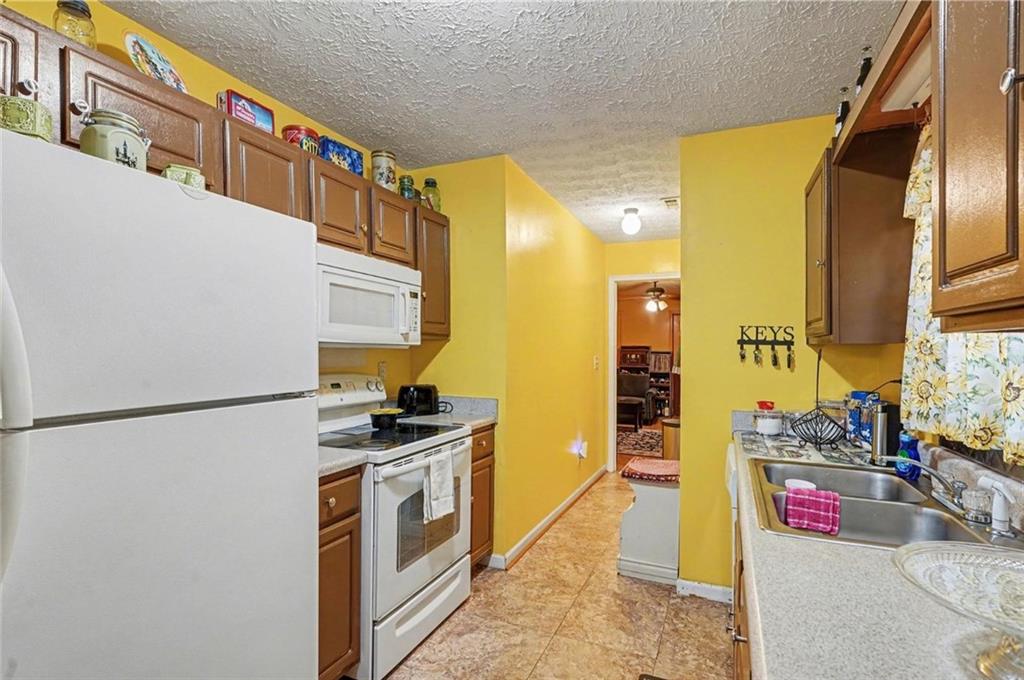 204 Hailey Lane Griffin, GA 30223 - Photo 13 of 32 a kitchen with stainless steel appliances granite countertop a sink and a refrigerator
