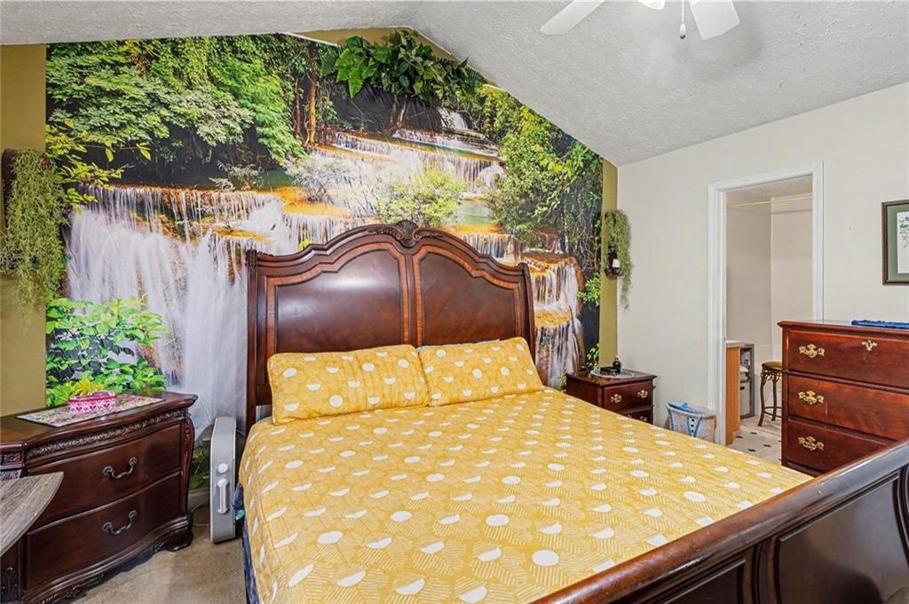 204 Hailey Lane Griffin, GA 30223 - Photo 14 of 32 a bedroom with a bed and a dresser