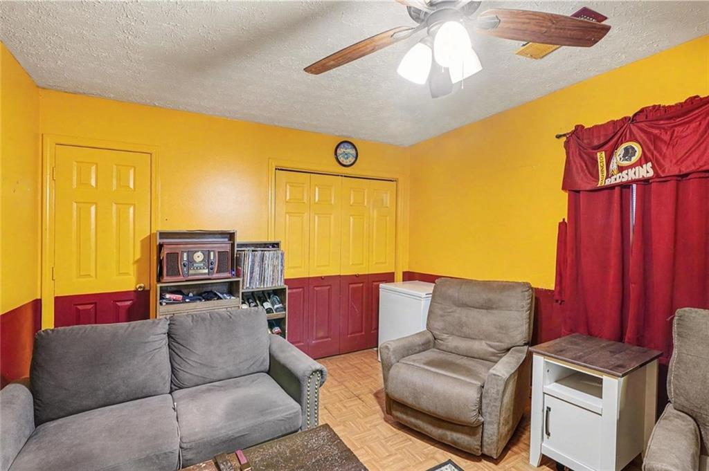 204 Hailey Lane Griffin, GA 30223 - Photo 27 of 32 a living room with furniture and a flat screen tv
