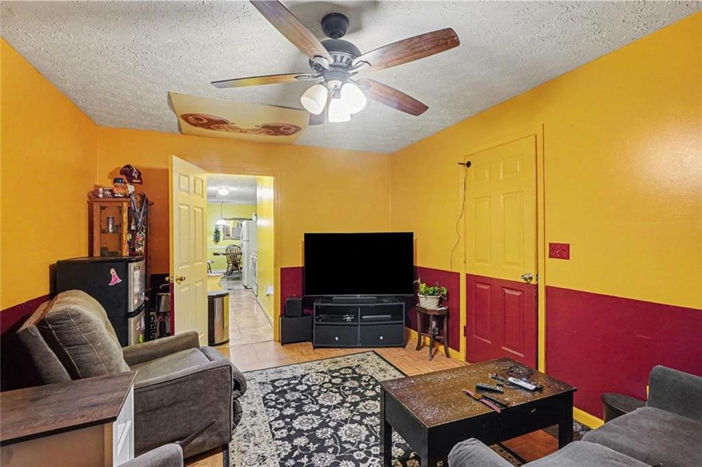 204 Hailey Lane Griffin, GA 30223 - Photo 28 of 32 a living room with furniture and a flat screen tv
