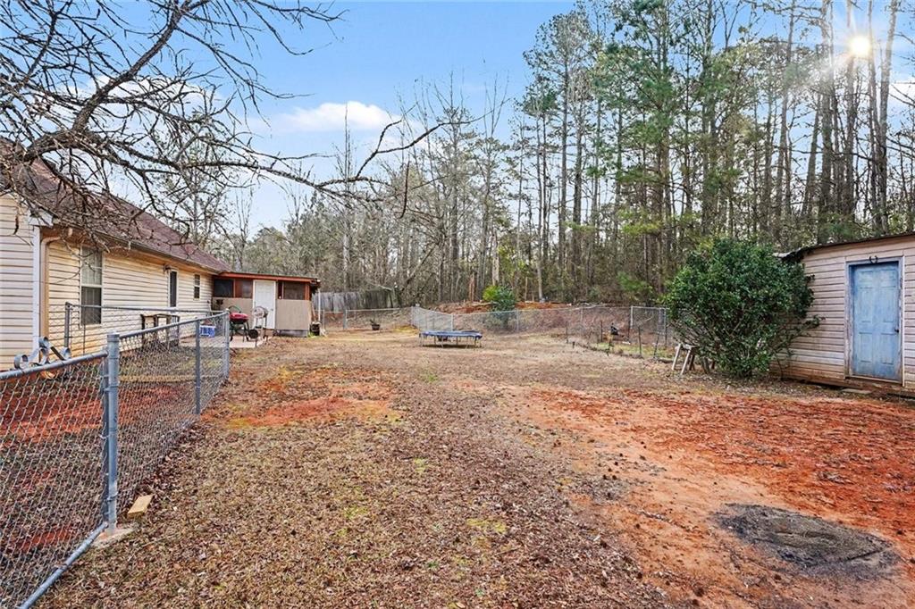 204 Hailey Lane Griffin, GA 30223 - Photo 32 of 32 a backyard of a house with table and chairs