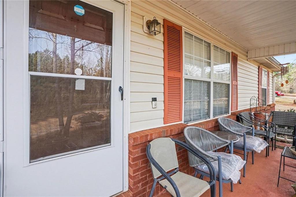 204 Hailey Lane Griffin, GA 30223 - Photo 4 of 32 a view of a porch with furniture and front door