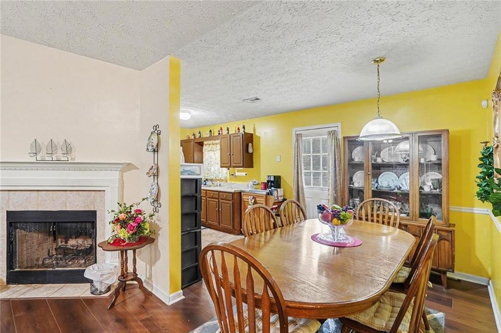 204 Hailey Lane Griffin, GA 30223 - Photo 6 of 32 a dining room with furniture a chandelier and wooden floor