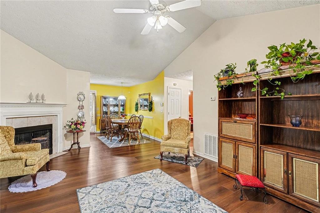 204 Hailey Lane Griffin, GA 30223 - Photo 8 of 32 a living room with furniture dining table and a fireplace
