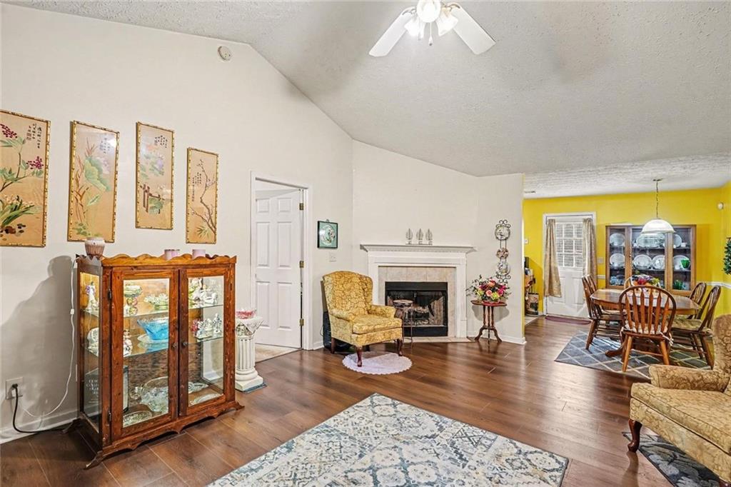 204 Hailey Lane Griffin, GA 30223 - Photo 9 of 32 a living room with furniture a fireplace and dining table