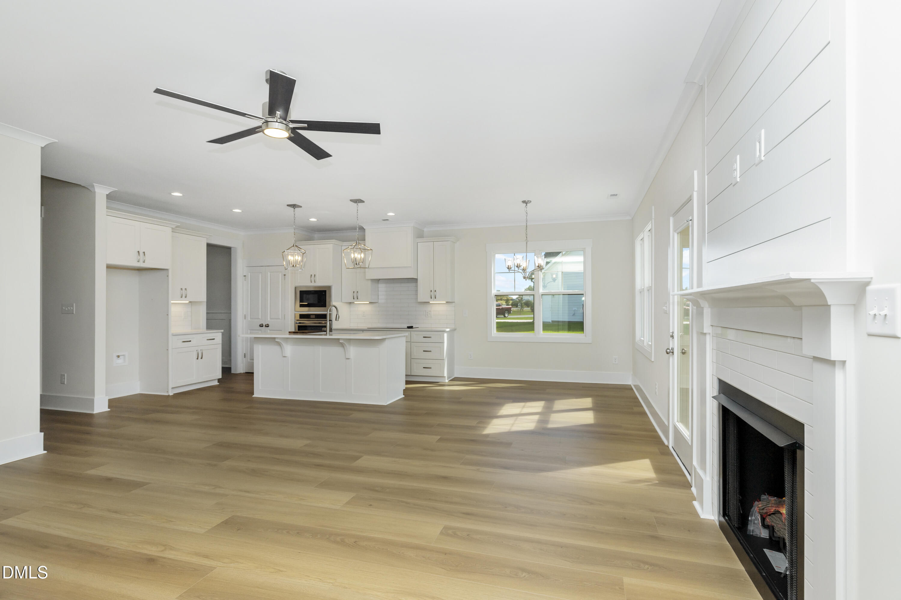 61 Croatoke Court Angier, NC 27501 - Photo 11 of 36 a view of kitchen and kitchen with fireplace wooden floor