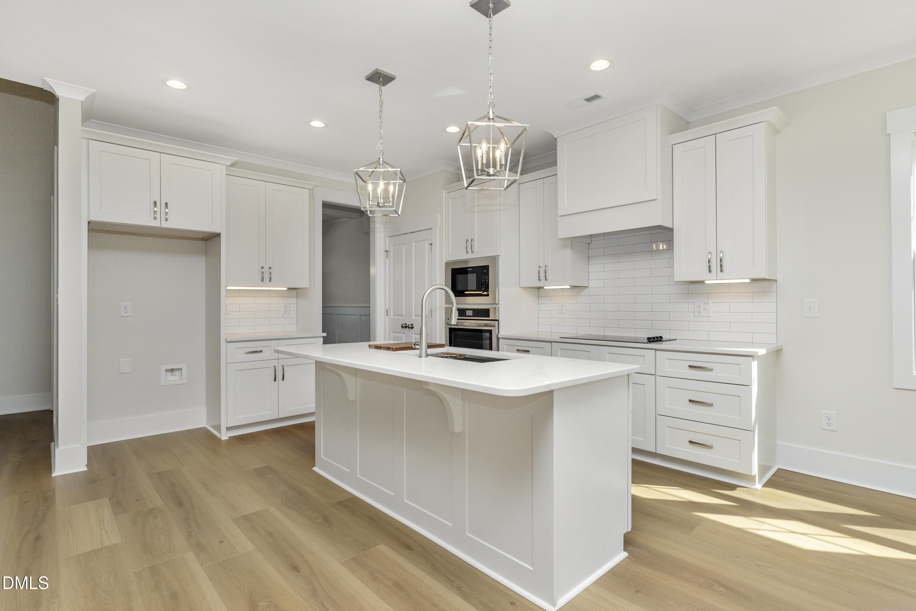 61 Croatoke Court Angier, NC 27501 - Photo 12 of 36 a kitchen with kitchen island a white counter top space cabinets and stainless steel appliances