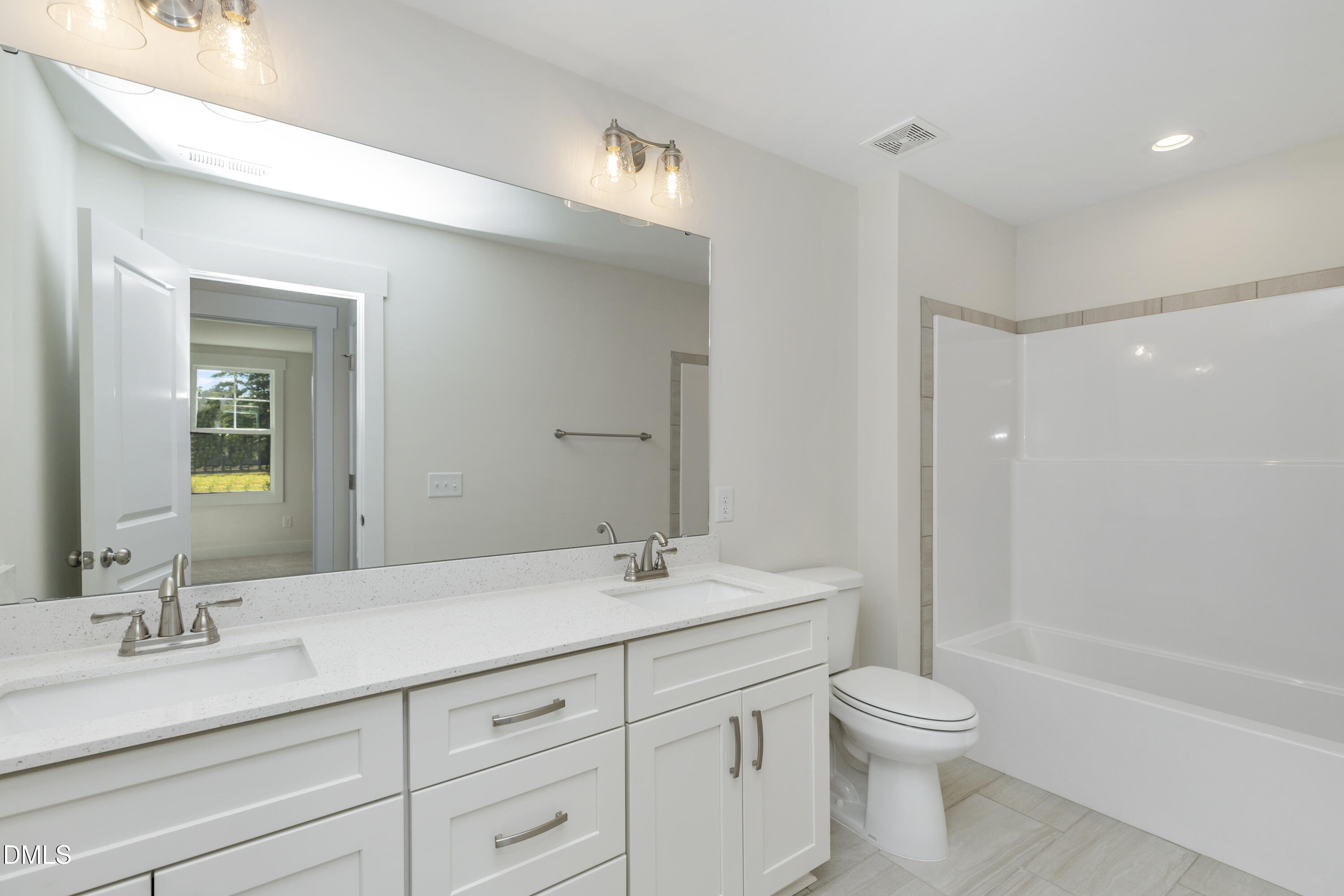 61 Croatoke Court Angier, NC 27501 - Photo 20 of 36 a bathroom with a granite countertop sink a toilet and shower