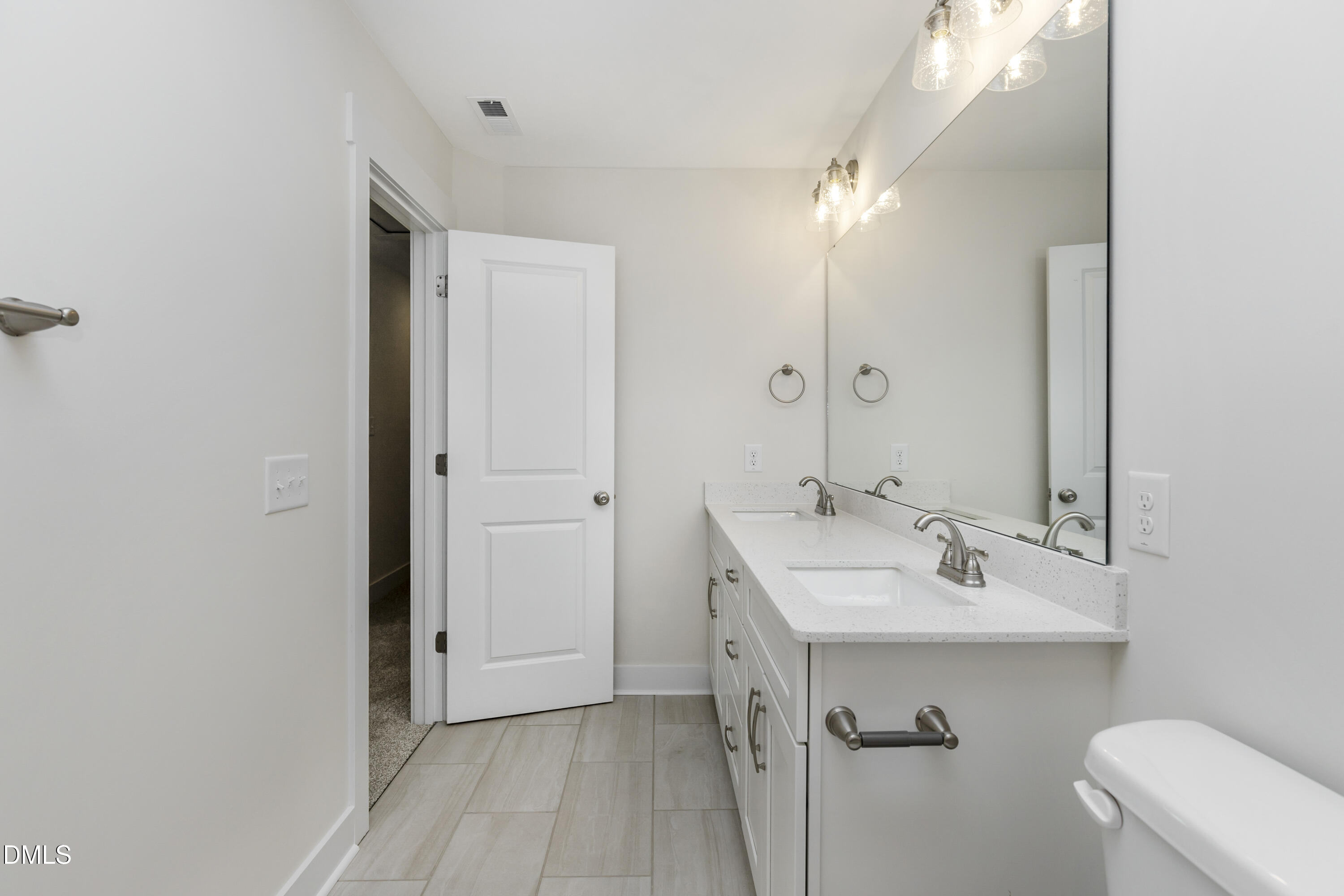 61 Croatoke Court Angier, NC 27501 - Photo 26 of 36 a bathroom with a sink and a mirror