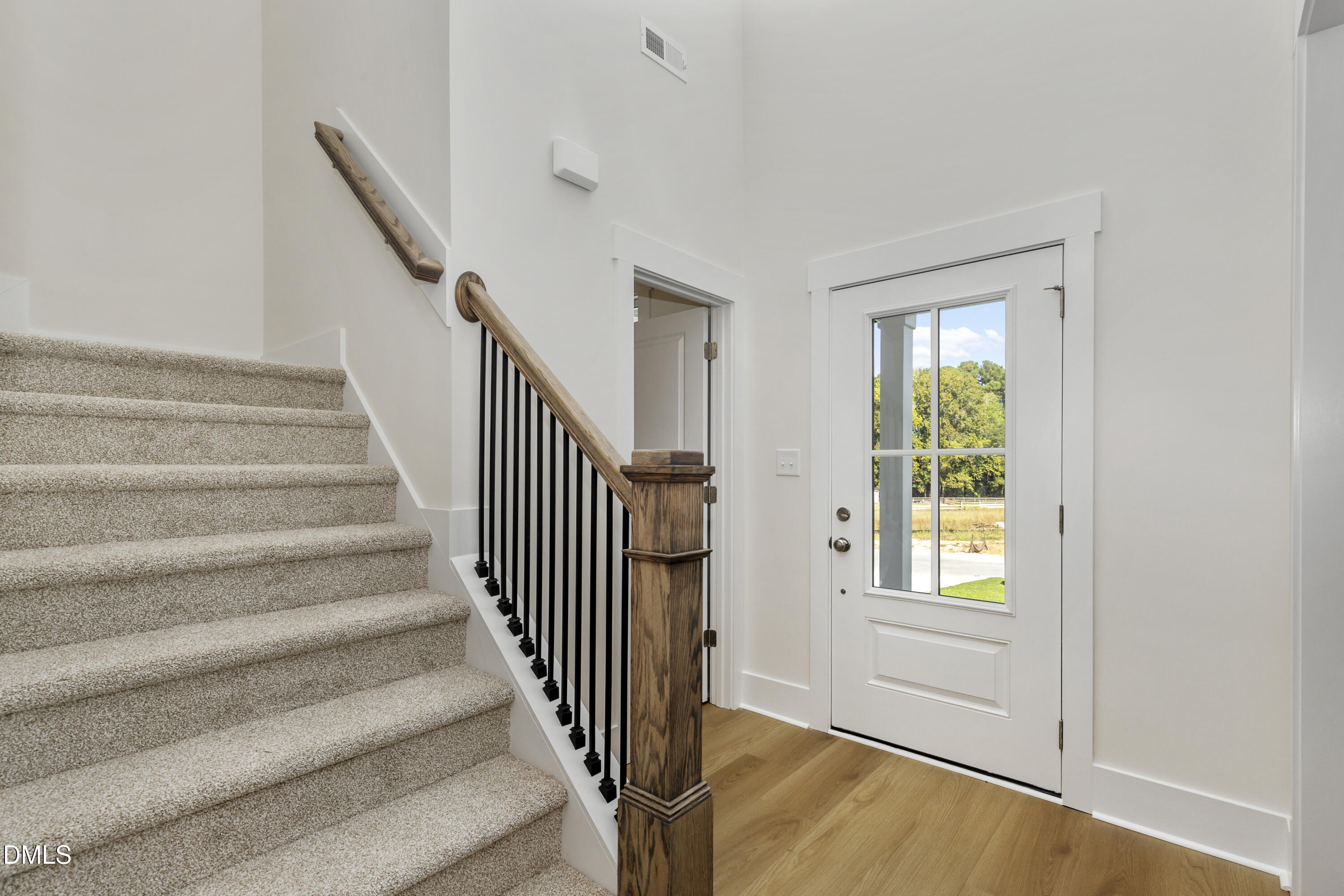 61 Croatoke Court Angier, NC 27501 - Photo 5 of 36 a view of entryway with wooden floor and front door