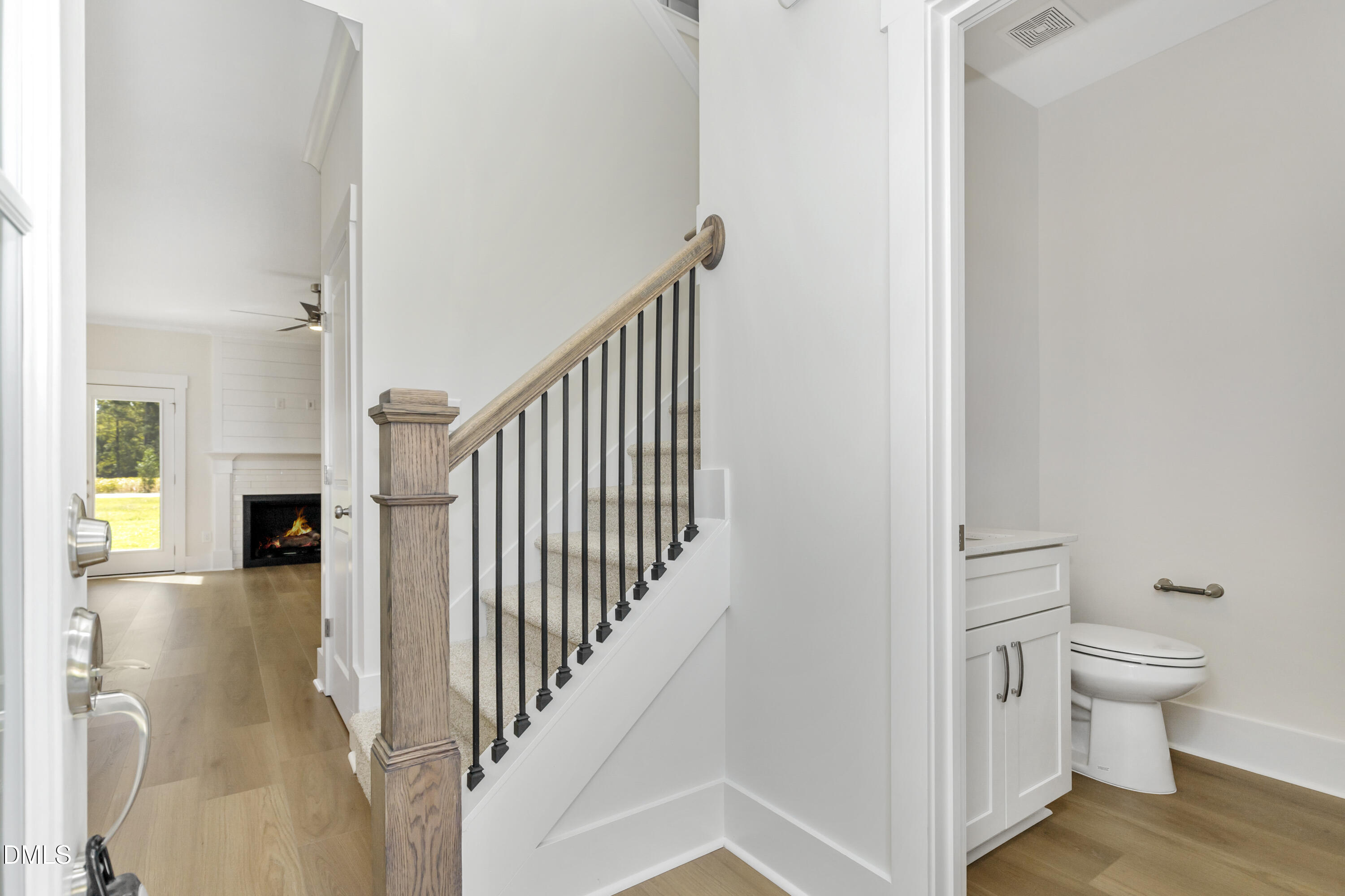 61 Croatoke Court Angier, NC 27501 - Photo 6 of 36 a view of a hallway with wooden floor and a bathroom