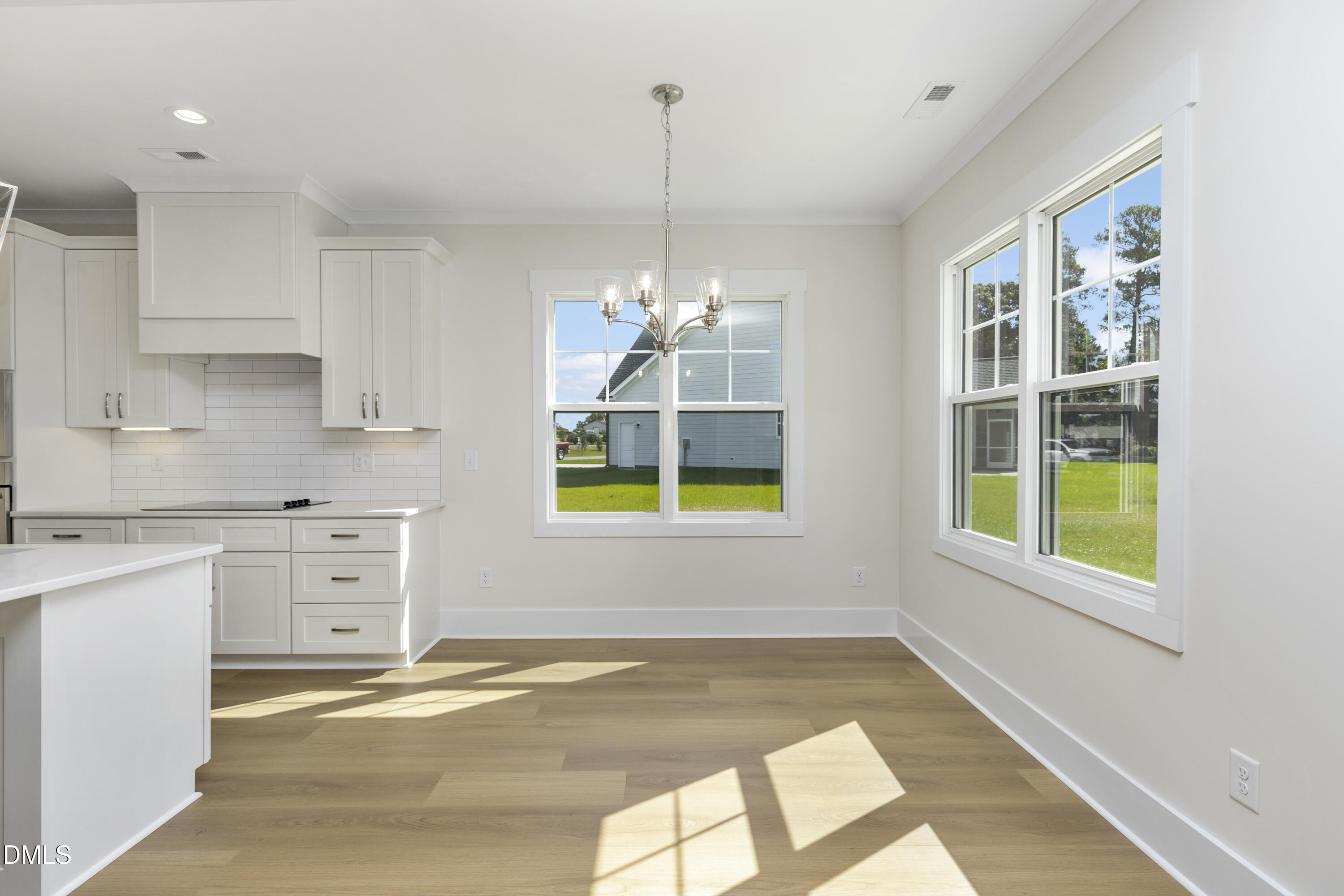 61 Croatoke Court Angier, NC 27501 - Photo 10 of 36 a kitchen with white cabinets and window