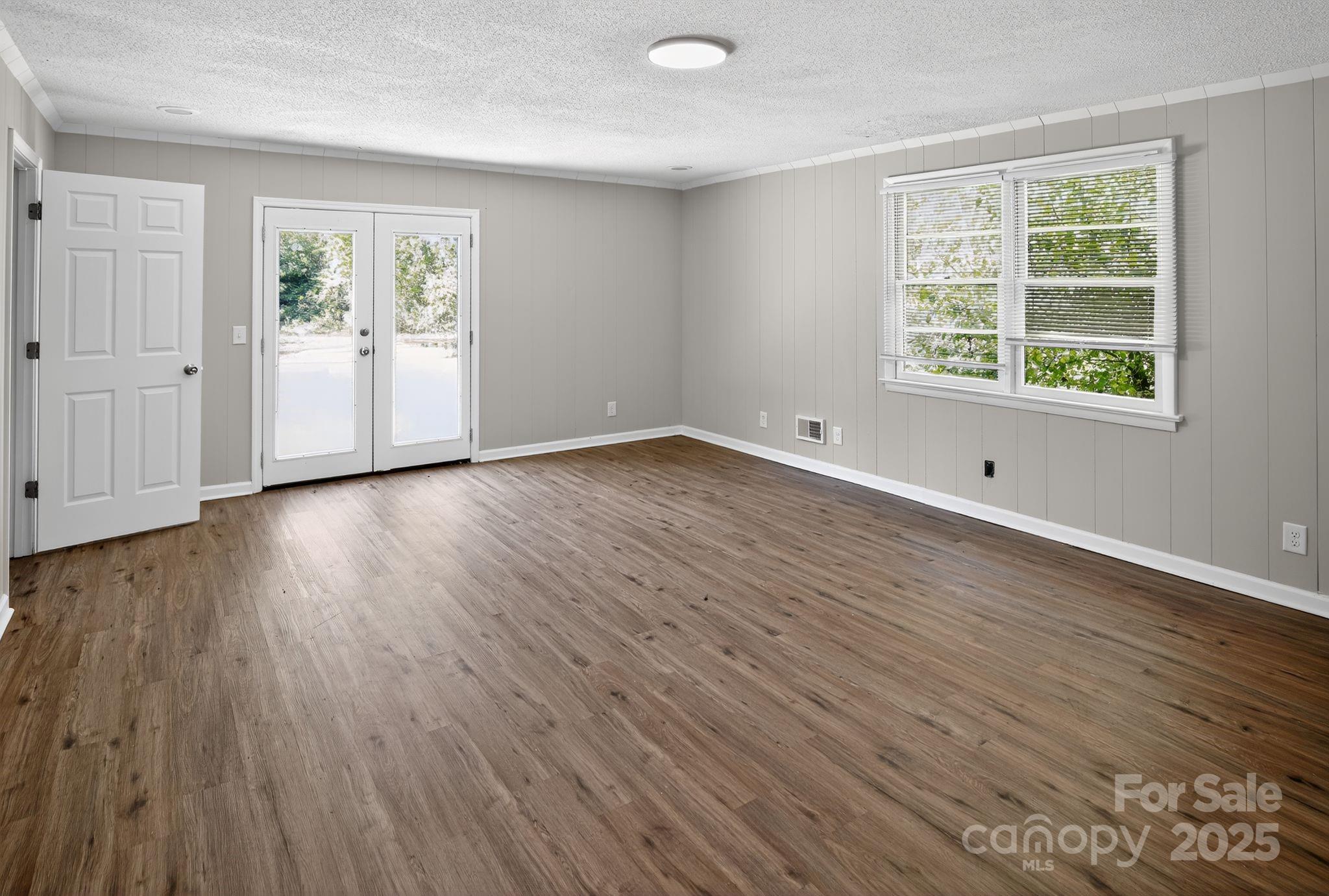 1527 Burnside Avenue Columbia, SC 29209 - Photo 11 of 31 an empty room with wooden floor and windows