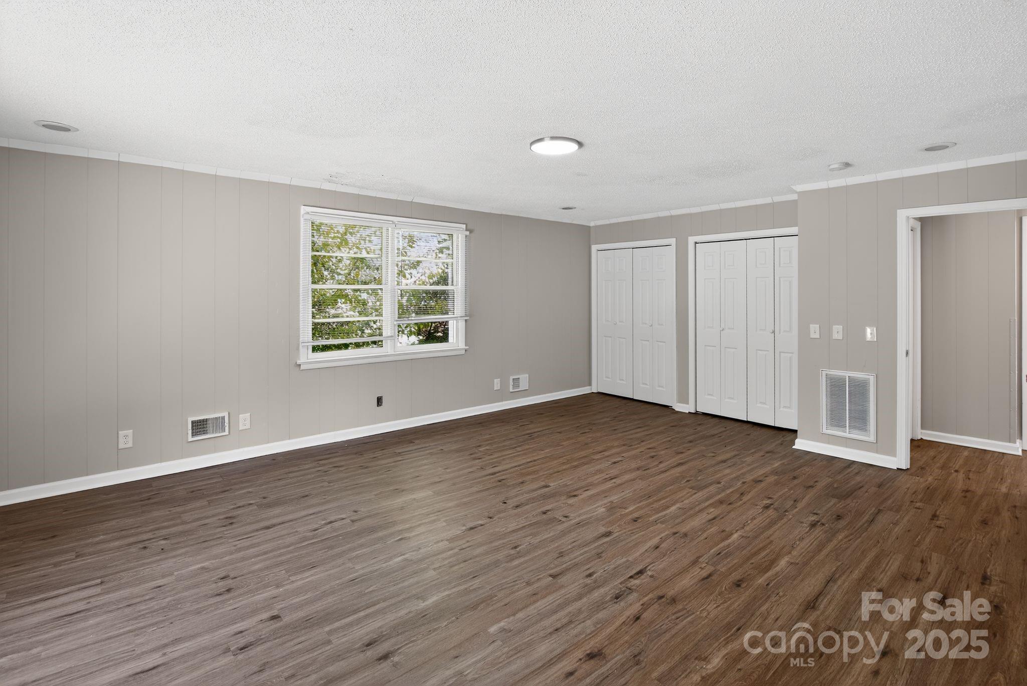 1527 Burnside Avenue Columbia, SC 29209 - Photo 21 of 31 a view of an empty room with wooden floor and a window