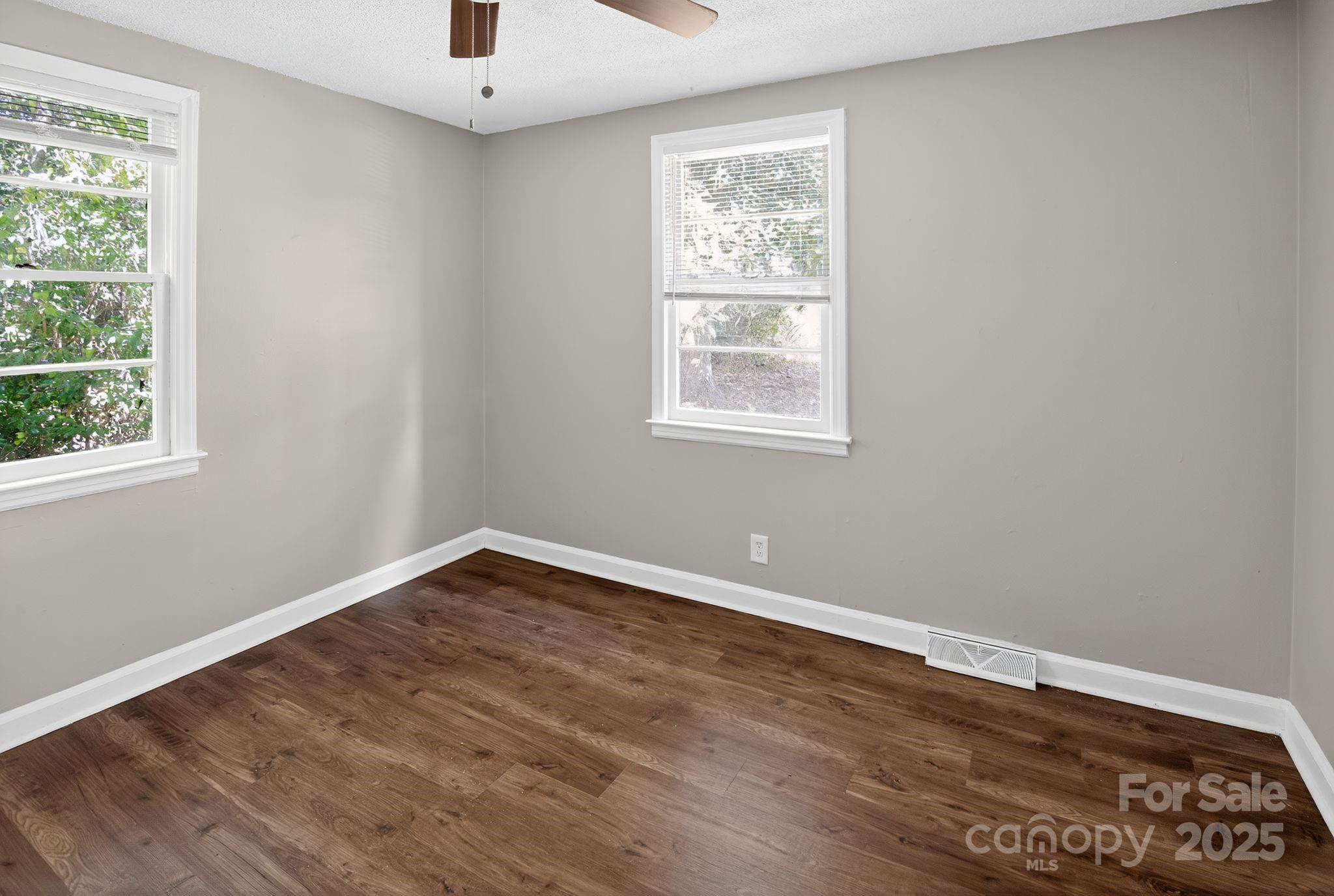 1527 Burnside Avenue Columbia, SC 29209 - Photo 9 of 31 an empty room with wooden floor and windows
