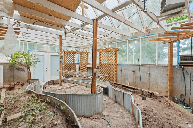 672 Perry Hollow Drive Mapleton, UT 84664 - Photo 103 of 106 Expansive greenhouse featuring an integrated planting system with corrugated metal borders, a transparent roof, and wood-framed lattice accents