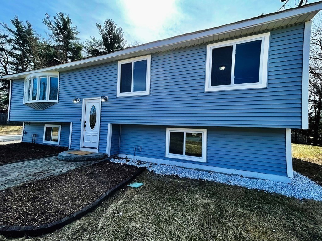 18 Haskell Road Pepperell, MA 01463 - Photo 1 of 36 a view of a brick house with a yard
