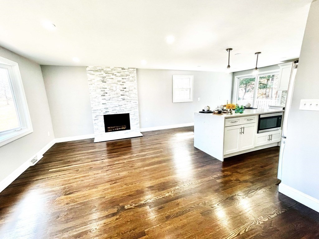 18 Haskell Road Pepperell, MA 01463 - Photo 16 of 36 a living room with stainless steel appliances kitchen island granite countertop a stove and a wooden floors