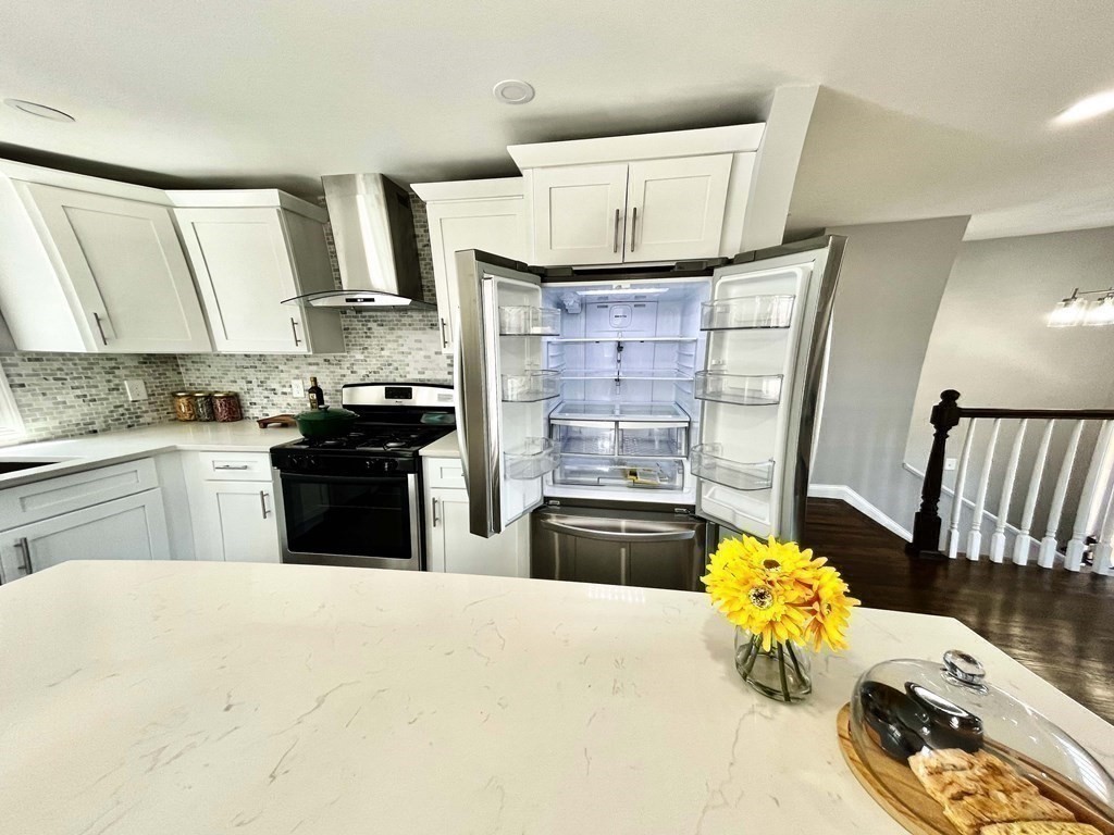 18 Haskell Road Pepperell, MA 01463 - Photo 18 of 36 a kitchen with a sink a stove and a refrigerator