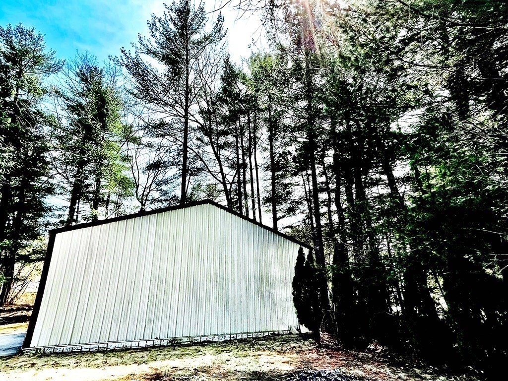 18 Haskell Road Pepperell, MA 01463 - Photo 8 of 36 a wooden fence with trees in the background