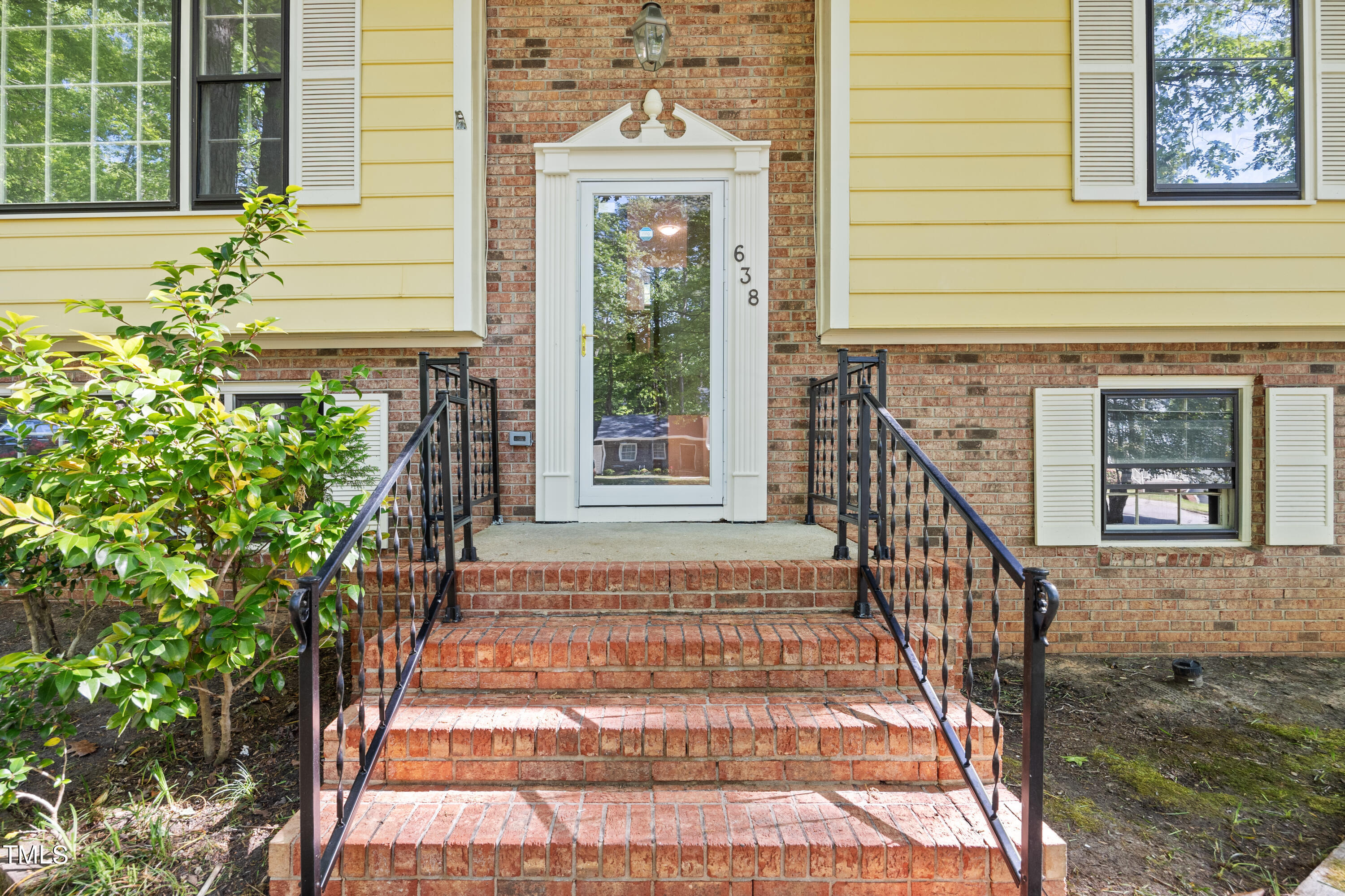 an entrance view of a house with stairs