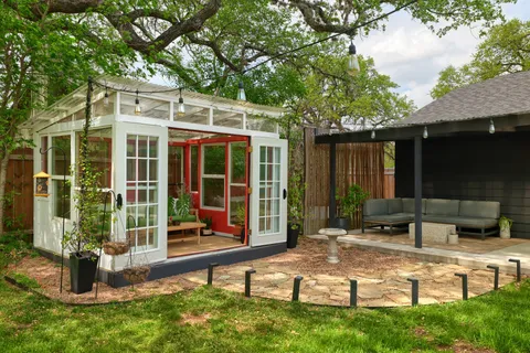 a view of a house with backyard porch and sitting area