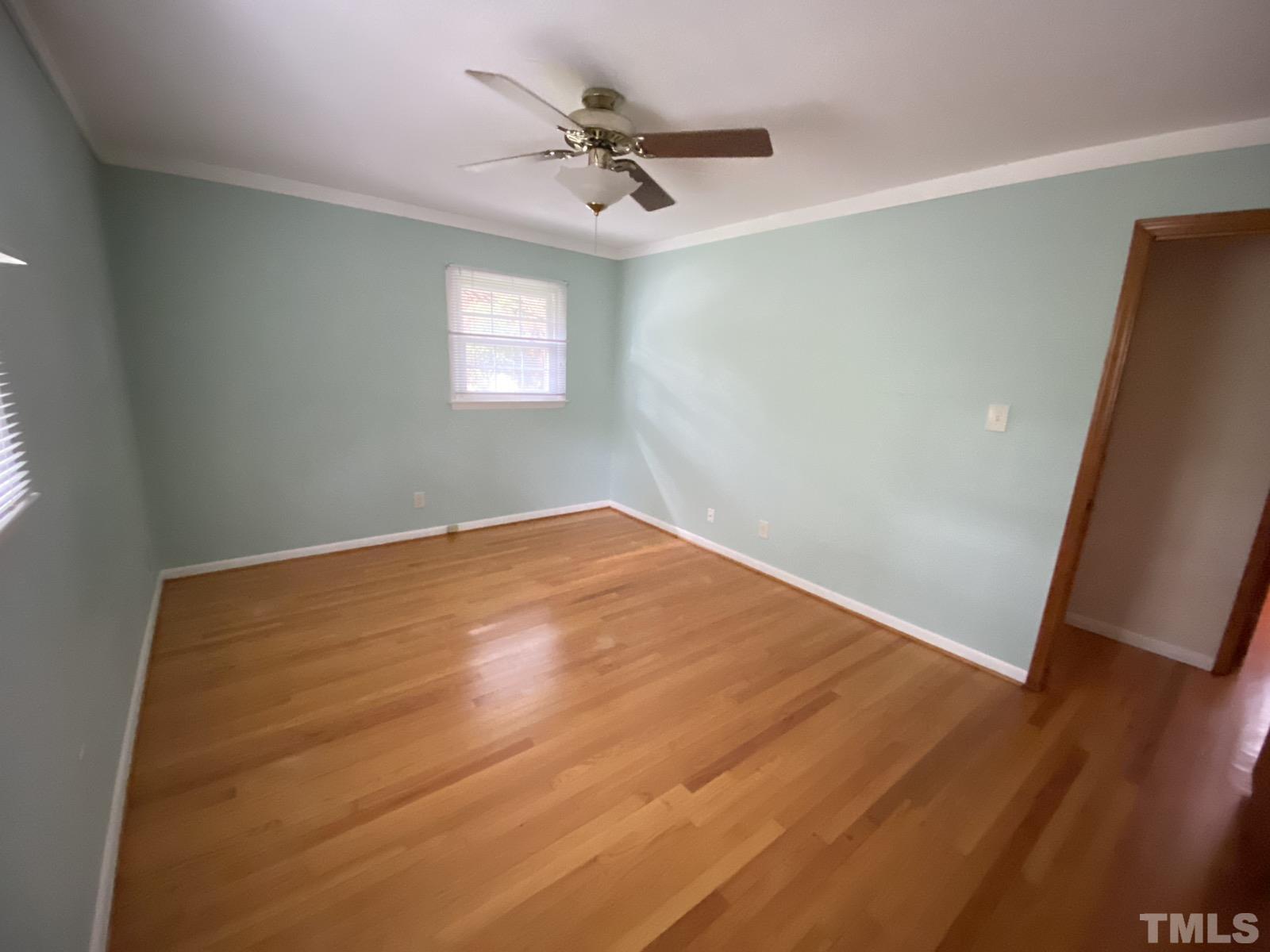 711 Kildaire Farm Road Cary, NC 27511 - Photo 11 of 19 an empty room with a window and a ceiling fan