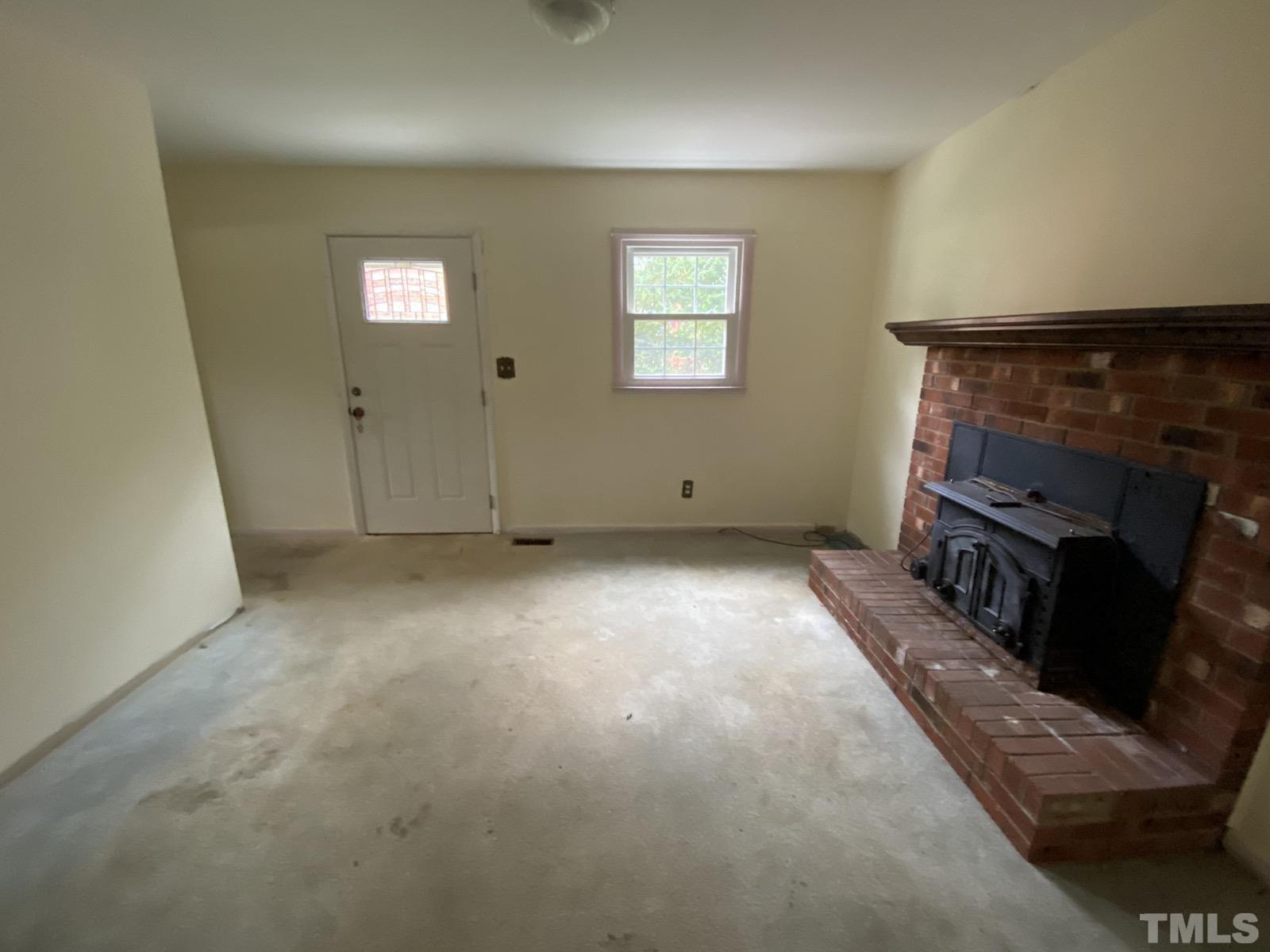711 Kildaire Farm Road Cary, NC 27511 - Photo 14 of 19 a view of empty room with window and fireplace