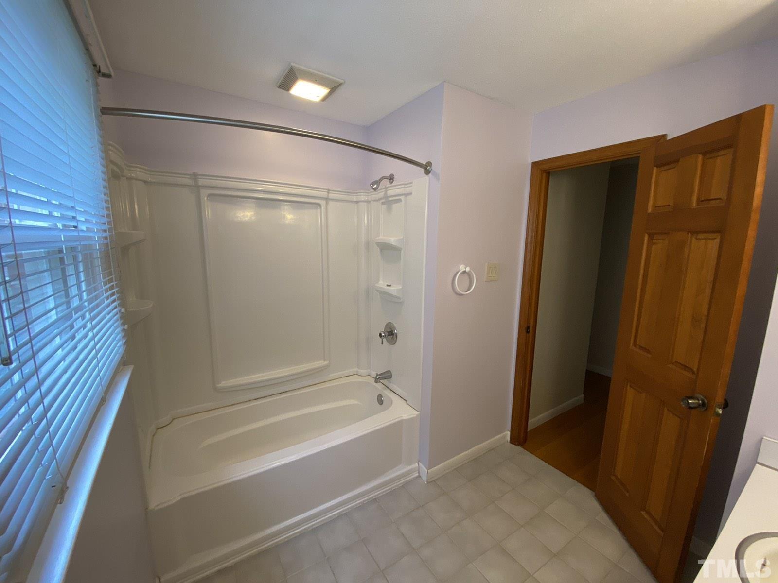711 Kildaire Farm Road Cary, NC 27511 - Photo 8 of 19 a bathroom with a bathtub and a shower
