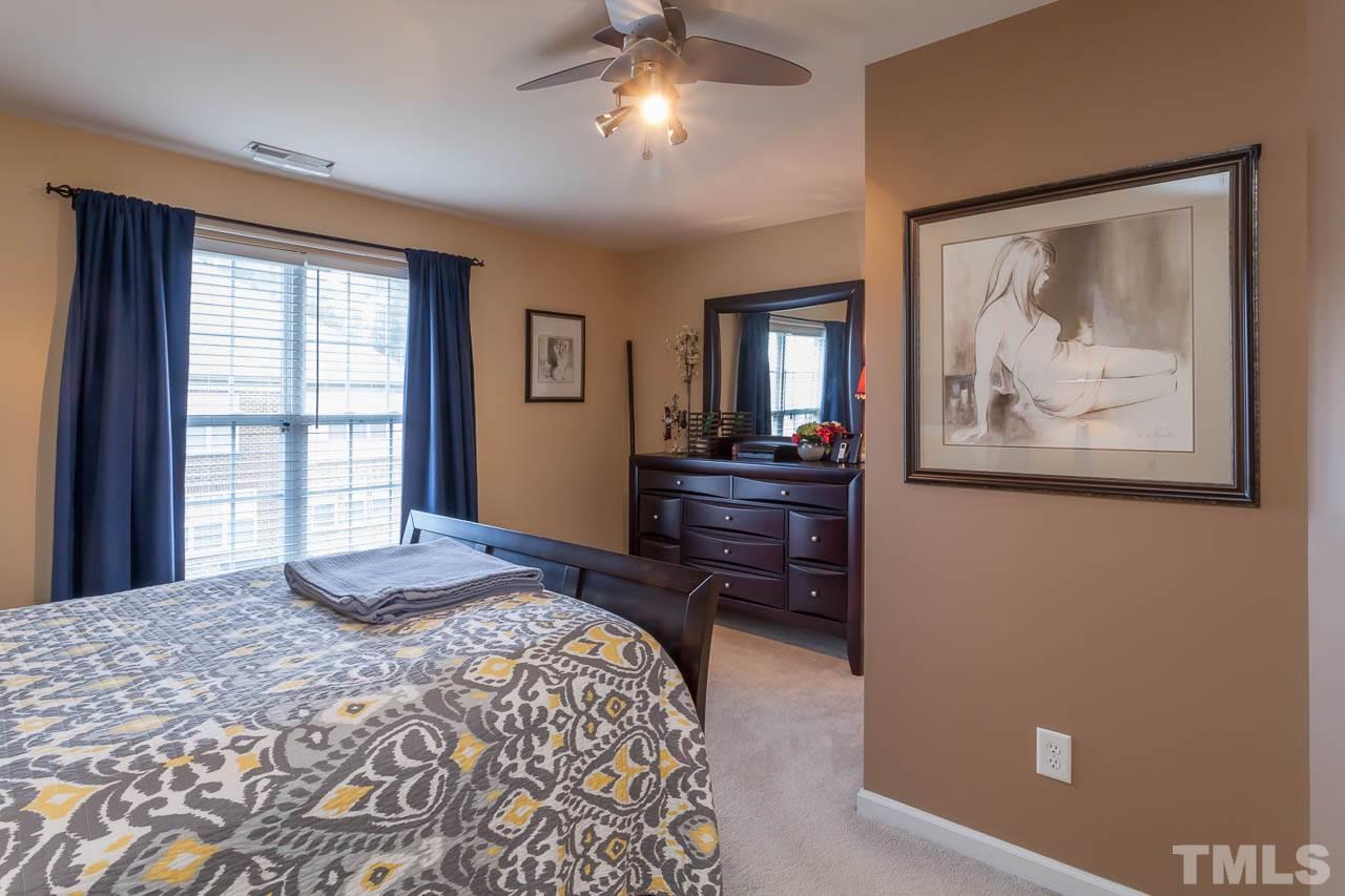 9909 Kedzie Court Raleigh, NC 27617 - Photo 2 of 22 a bedroom with a bed and a painting on the wall