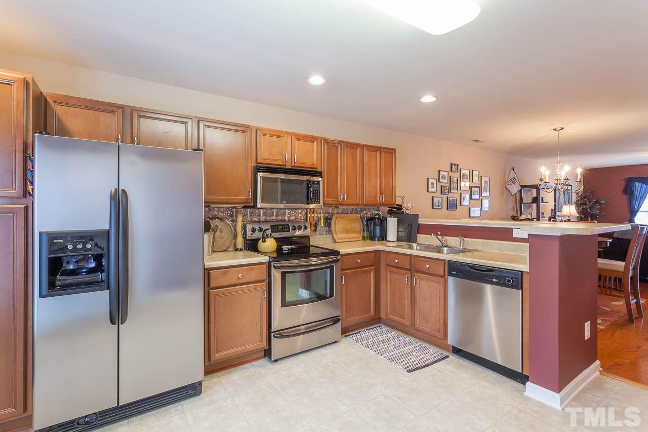 9909 Kedzie Court Raleigh, NC 27617 - Photo 13 of 22 a kitchen with stainless steel appliances granite countertop a refrigerator and a stove top oven