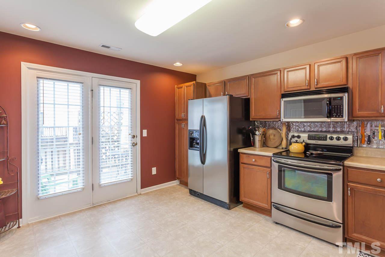 9909 Kedzie Court Raleigh, NC 27617 - Photo 14 of 22 a kitchen with stainless steel appliances granite countertop a refrigerator stove and sink