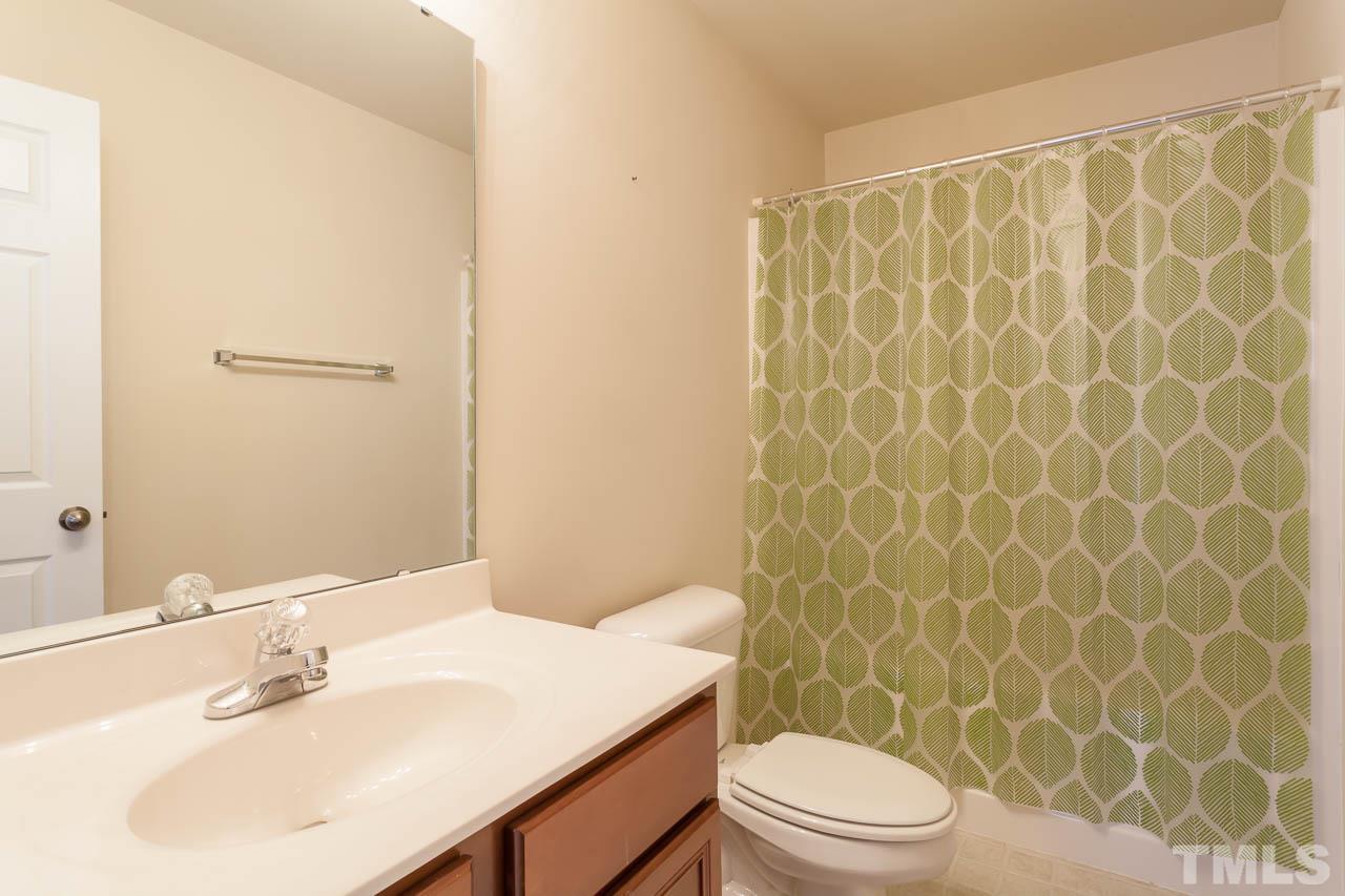 9909 Kedzie Court Raleigh, NC 27617 - Photo 15 of 22 a bathroom with a sink a toilet and shower