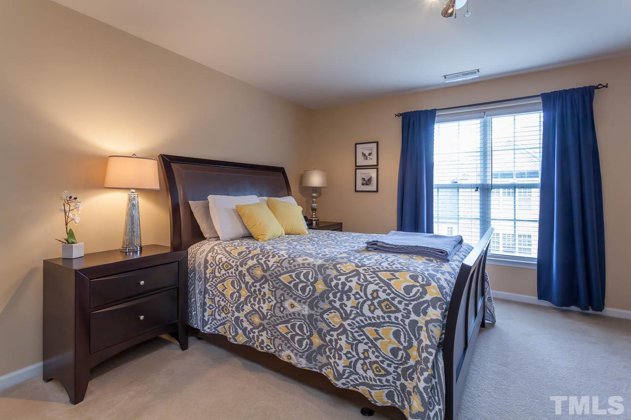 9909 Kedzie Court Raleigh, NC 27617 - Photo 3 of 22 a bedroom with a bed and a window