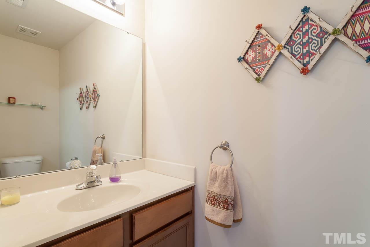 9909 Kedzie Court Raleigh, NC 27617 - Photo 7 of 22 a bathroom with a sink and a mirror