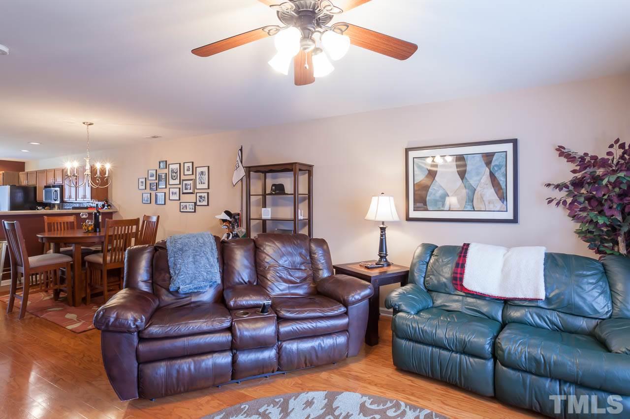 9909 Kedzie Court Raleigh, NC 27617 - Photo 8 of 22 a living room with furniture kitchen view and a chandelier