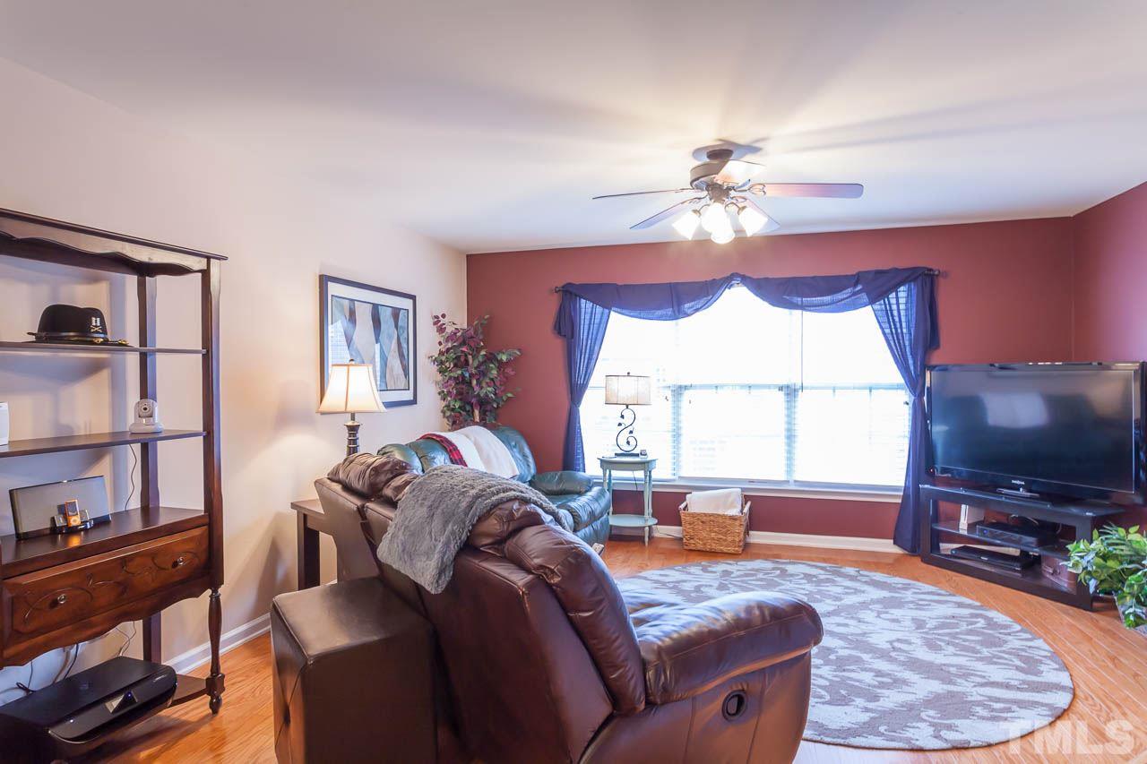 9909 Kedzie Court Raleigh, NC 27617 - Photo 10 of 22 a living room with furniture a flat screen tv and a window